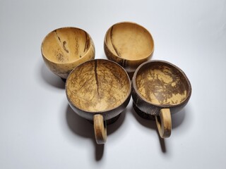 Kitchen utensils made of wood and brown coconut shells, namely shell glasses and large rice spoons