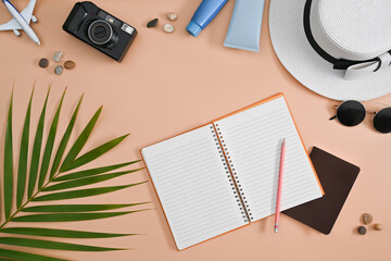 Traveler accessories with passport, sunglasses, camera and hat on beige background. Travel, summer and holiday concept.