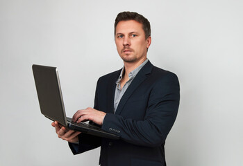 Young businessman using laptop computer on white background