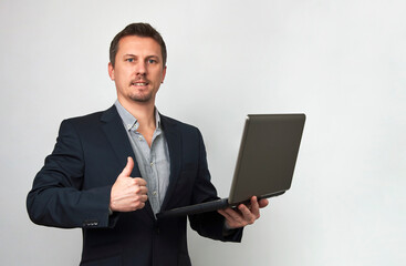 Young businessman using laptop computer on white background