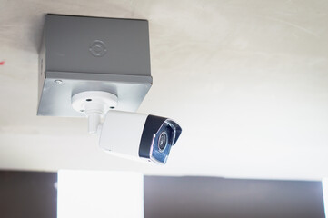 CCTV surveillance security camera video equipment outdoor safety system area control and copy space.Security camera  under the ceiling. Private property protection.CCTV on location.