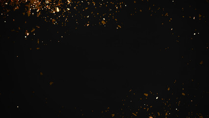 Black background with shiny golden pieces.