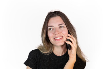 Fototapeta premium Young beautiful happy woman talking on the phone. She is smiling. Isolated white background.