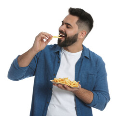Young man eating French fries on white background