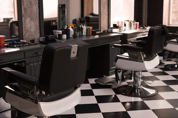 Stylish monochrome interior of modern barbershop. Equipped workplace