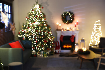 Obraz na płótnie Canvas Blurred view of decorated room with Christmas tree and fireplace