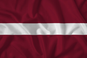 Latvia flag with fabric texture. Close up shot, background