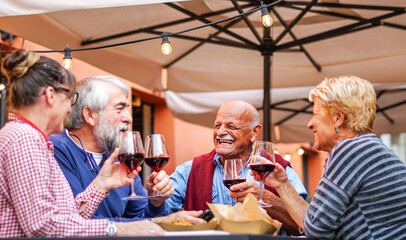 Group of old people eating and drinking outdoor