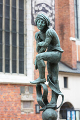Naklejka premium Figurine student, a copy of the form from the altar of Veit Stoss, fountain in the square of St. Mary's, Krakow, Poland