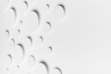 Abstract geometric texture of flying white paper ovals in shining light with soft shadows as mess pattern, top view, border, copy space. Simple delicate clean airy calm background in minimal style.