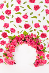 Summer fresh pink roses as framing of circle arch with green leaves and buds soar as pattern on abstract white scene mockup for presentation cosmetic products, goods, advertising, design vertical.