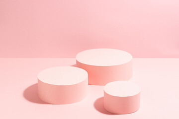 Fashion stage with set of three pastel pink round podiums top view mockup in sunlight with shadow, copy space. Trendy template showcase for presentation cosmetic product, goods, advertising, design.