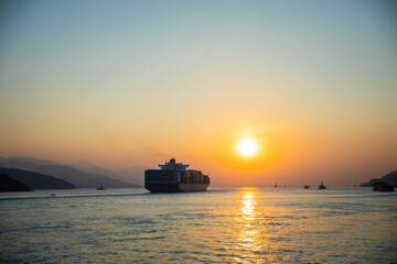 Cargo Carrier sailing in ocean, sunset moment