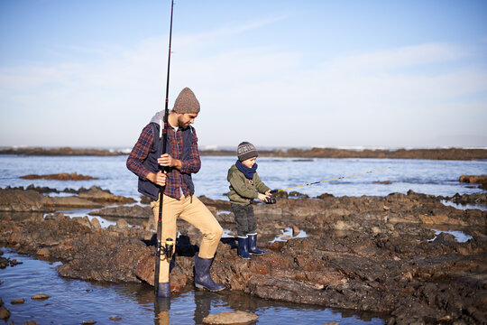 Snail fishing. Shot of a father and son out fishing together by the sea.