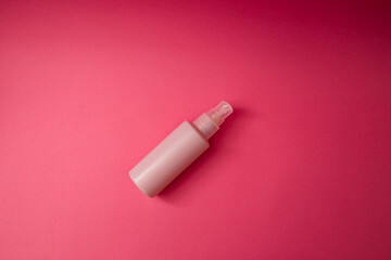 Jar with antiseptic on a pink background