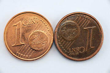 New and old one euro coin on white background