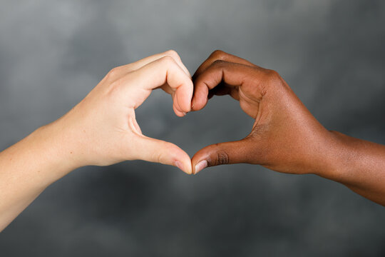 Two hands making a heart. Multiethnic hand heart.