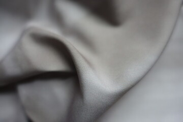 Close shot of viscose and polyester fabric with tie dye pattern in shades of gray