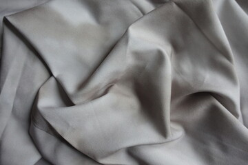 Rumpled viscose and polyester fabric with tie dye pattern in shades of gray