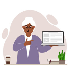 Screaming grandmother holding a laptop computer with one hand and pointing at it with the other. Laptop computer technology concept.
