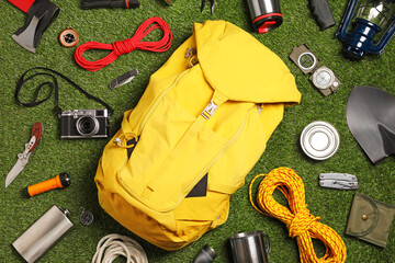Set of traveler's equipment on green grass, flat lay