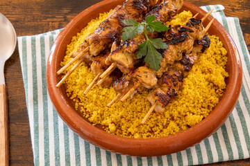 top view of chicken skewer laid on tabbouleh