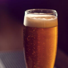 glass of beer close up on wooden table square