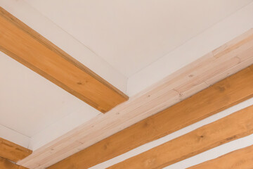 Wooden boards abstract interior plank ceiling design on background of white wall texture