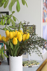 Bouquet of yellow tulips and eucalyptus