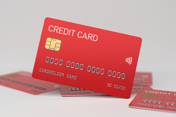 Red plastic credit cards on a white background. Banking and e-commerce concept. Bank card without branding, selected focus
