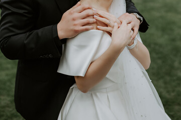 Obraz na płótnie Canvas Close-up of groom's hand holding bride's hand tender