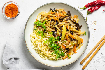 Asian vegetable stir fry noodles in a bowl. Top view, copy space.