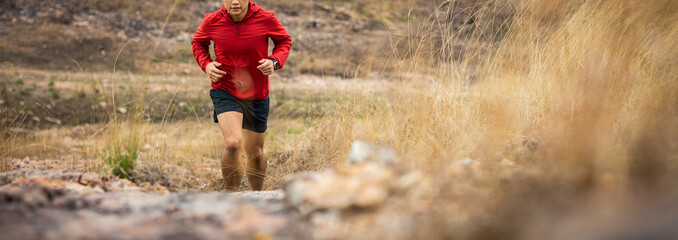 Trail runner man running on rocky mountain. Athlete jog exercising outdoor for healthy. Confident...