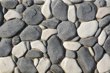 Foundation, fence, masonry wall. Cobblestones bonded with cement.