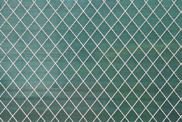 White Painted Wire Fence with Green Plastic Screen in Close Up 