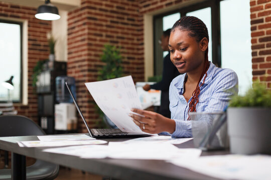 Marketing Agency Office Person Having Management Documentation While Sitting At Desk. Young Confident Business Woman Reviewing Accounting Annual Results And Financial Plan.