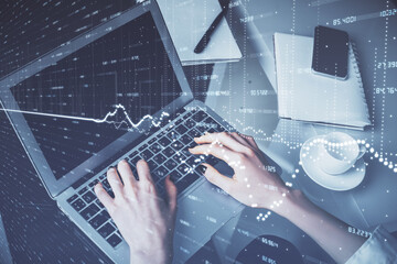 Double exposure of woman hands typing on computer and forex chart hologram drawing. Stock market invest concept.