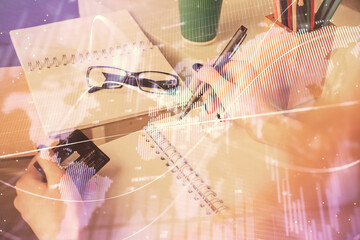 Multi exposure of woman on-line shopping holding a credit card and financial graph drawing. Stock market E-commerce concept.