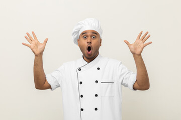 Wow excited face Young handsome asian man chef in uniform with hat standing posting looking camera on isolated. Cooking indian man Occupation chef People in kitchen restaurant and hotel.