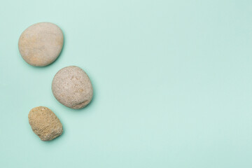 Fototapeta na wymiar Set of sea stones on color background, top view