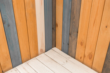 Wooden colored boards corner joint in the interior of the decor room decoration design background