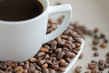 Coffee cup with coffee beans close up