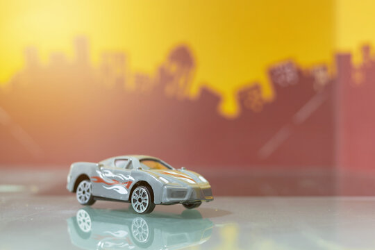 Grey racer car toy selective focus on blur city background