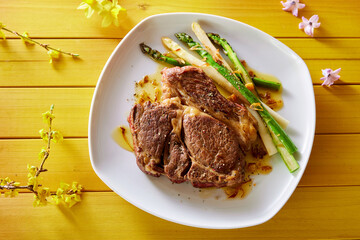 Rib eye steak and asparagus on plate