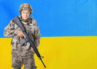 Armed soldier in military camouflage uniform and Ukrainian flag on background, space for text. Stop...