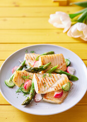 Grilled fish fillet with vegetables on plate