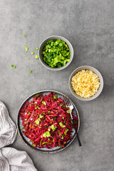 Vegetarian salad with couscous and grated beets, parsley and dill and green onions, light healthy tasty salad