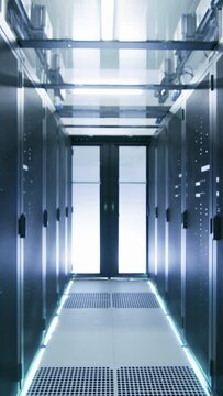 Camera Walk-Through Shot of a Working Data Center With Rows of Rack Servers.