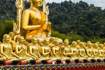 Lot of Golden Statue of Buddha sitting in meditation Belief Faith and Worship concept. Big buddha...