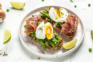 Ketogenic diet meal Poached egg with asparagus spears and prosciutto. banner, menu recipe place for text, top view